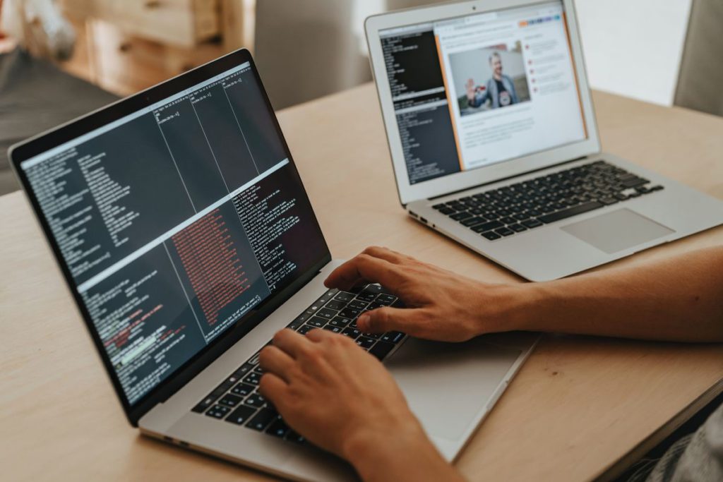 An image showing coding on two laptops.