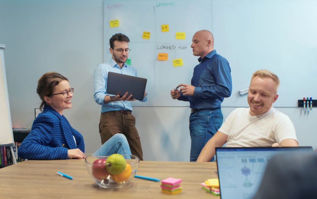 An image showing people talking in a room.