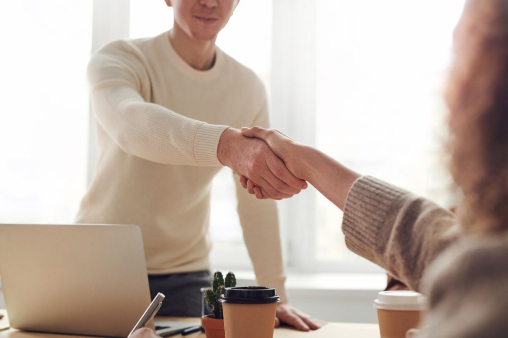 A screen showing a meeting between two people.