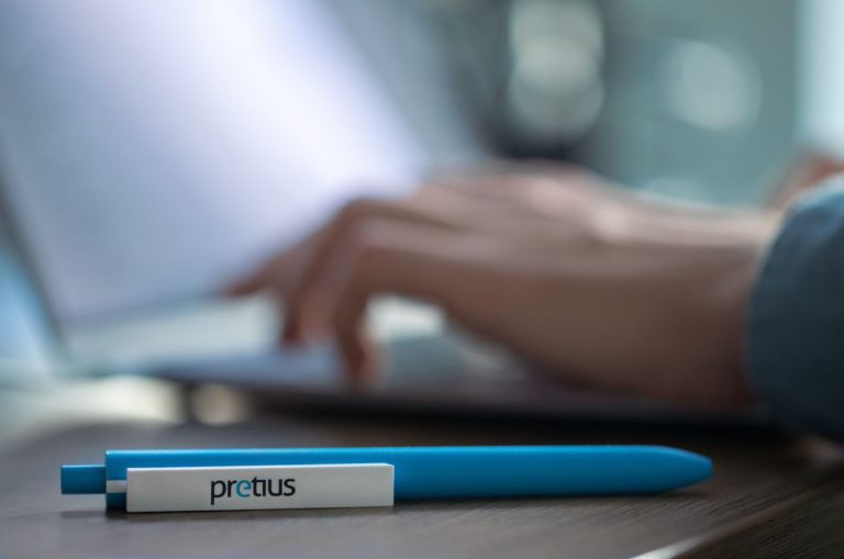 An image showing a laptop and a pen.