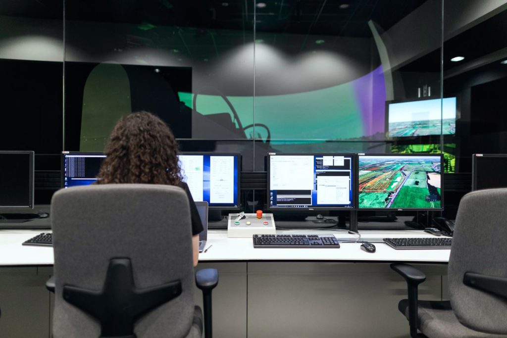 An image showing a person sitting behind a desk.