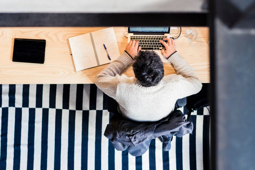 An image showing a man behind a desk.