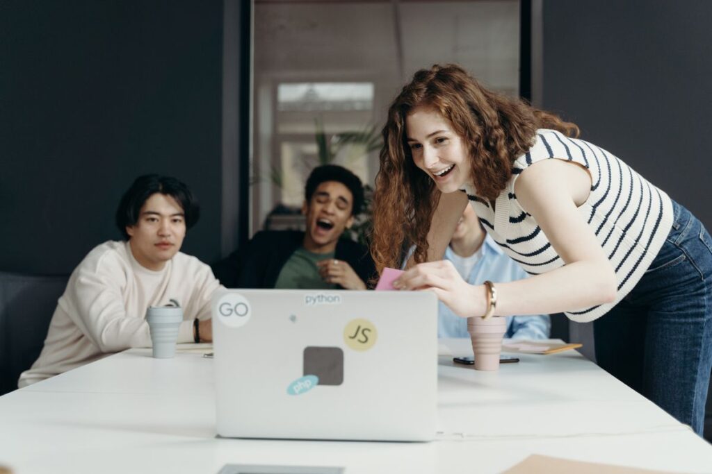 A picture showing a team with a laptop.